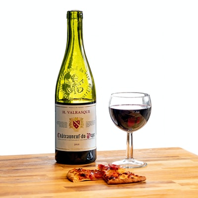 H. Valrasque Chateauneuf-de-Pape bottle and slices of pizza
